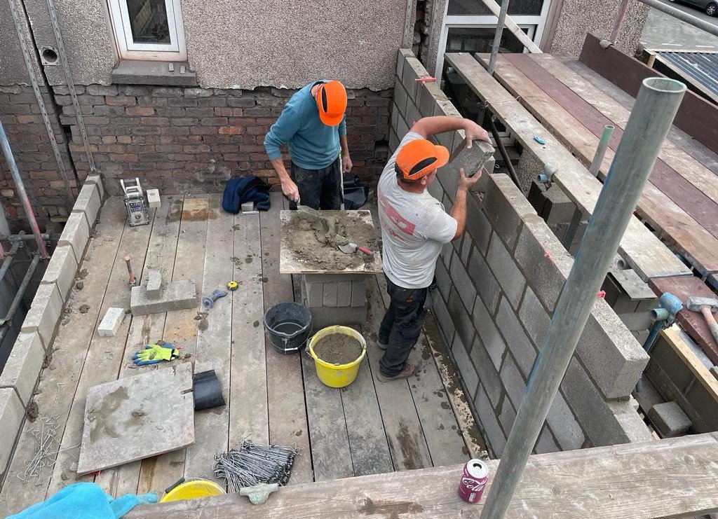 finding the right builder - builders constructing a new wall to the house extension