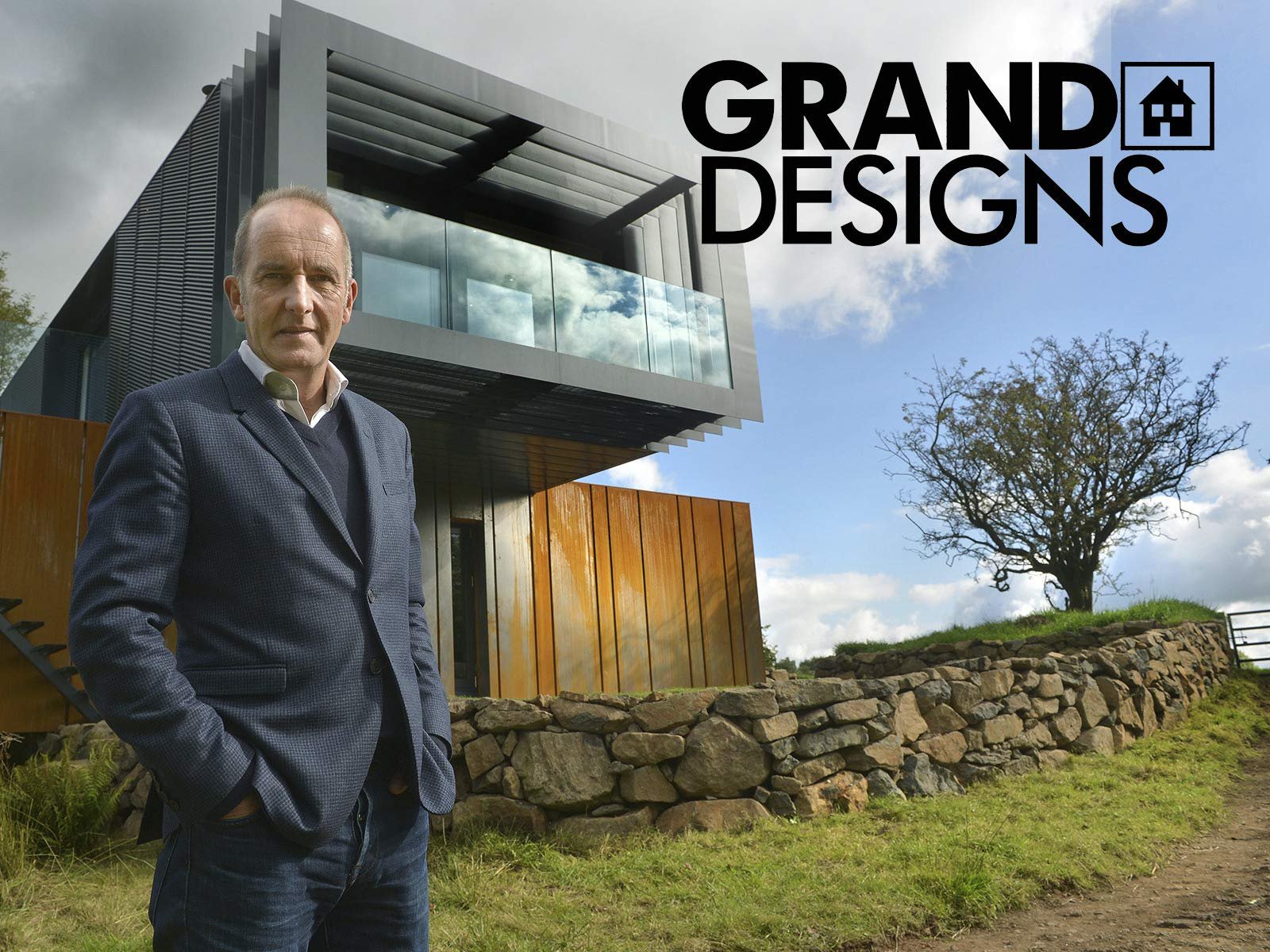 Exploring the best TV Design Programmes - Kevin McCloud stood in front of a modern new build house